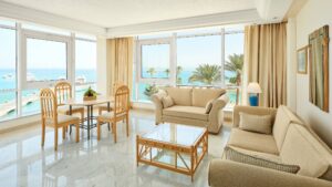 Bright living room with beige furniture overlooking a sea view at Hurghada Marriott Beach Resort.