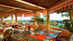 Hurghada Marriott Beach Resorts outdoor restaurant with ocean views, wicker chairs, and orange awnings.