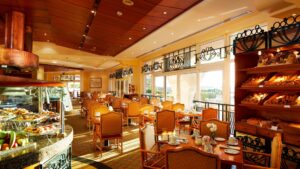 A bright restaurant at Hurghada Marriott with dining tables and a bakery display.