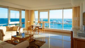 Bright room with large windows showcasing yachts and ocean views at Hurghada Marriott Beach Resort.