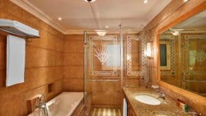 Luxurious Sheraton Soma Bay bathroom with a bathtub, glass shower, and large mirrored vanity.