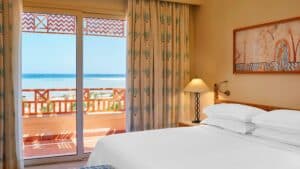 Sheraton Soma Bay room with ocean-view balcony and decorative curtains.