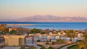 Sheraton Soma Bay: A beach resort with cabanas, palm trees, and ocean views under a clear sky.