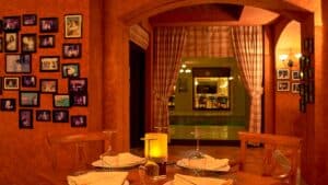 Cozy Sheraton Soma Bay setting with a candlelit table and framed photos on the wall.