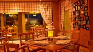 A cozy Sheraton Soma Bay restaurant with a set table and framed photos adorning the wall.