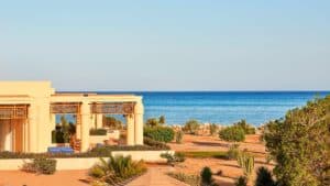 Beachfront villa at Sheraton Soma Bay with a clear blue sky and ocean backdrop.