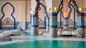 Sheraton Soma Bay: Indoor pool with ornate columns and teal water in a bathhouse setting.