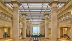 Grand Sheraton Soma Bay lobby with tall columns and a skylight ceiling.
