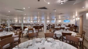 Elegant restaurant interior aboard the MS Grand Mandarin Nile Cruise, set under soft lighting.