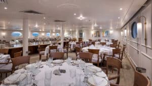 Elegant, spacious dining room aboard the MS Grand Mandarin Nile Cruise with set tables and ambient lighting.