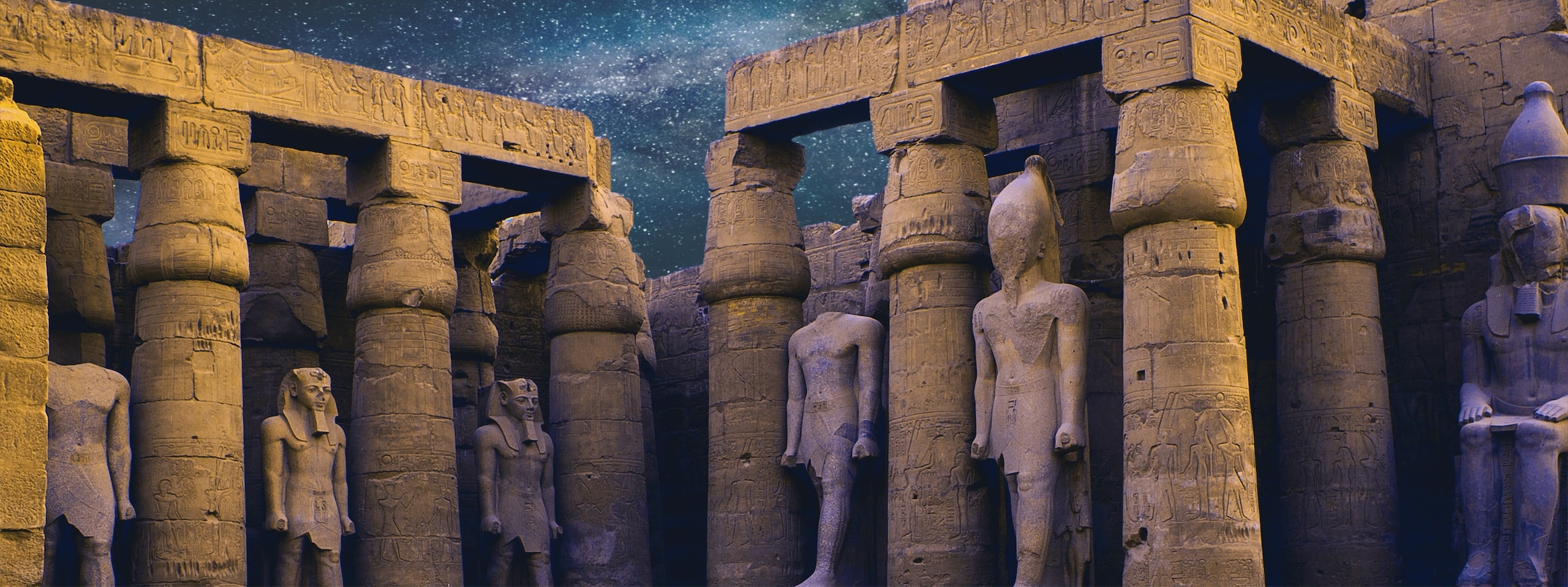 Ancient Egyptian ruins with stone pillars and statues under a starry night, perfect for Egypt videos.