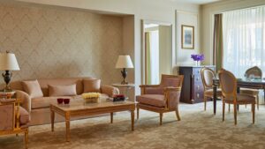 Elegant Four Seasons room with a sofa, armchairs, and a dining table with chairs.