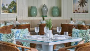 Elegant restaurant setting at Four Seasons Hotel Cairo, with crystal glasses and patterned cushions.