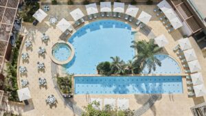 Aerial view of Four Seasons Nile Plaza pool with loungers and umbrellas.