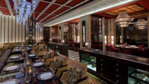 Elegant restaurant at the Four Seasons Hotel Cairo with chandeliers and neatly set tables.