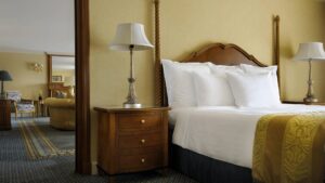 Cairo Marriott room with a bed, lamps, and a nightstand next to a sitting area.