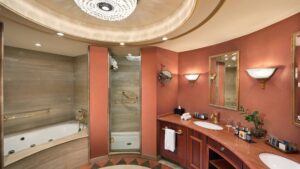 Elegant bathroom at Cairo Marriott Hotel with tub, shower, double sinks, and chic lighting.