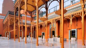 Ornate orange courtyard at Cairo Marriott, with arches and reflective marble floors.
