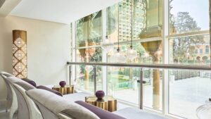 Spacious lounge with large windows, decorative lamps, and views of Cairo Marriotts garden.