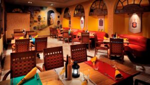 Cozy restaurant with wooden tables, red chairs, and a Cairo Marriott Mediterranean vibe.