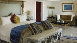 Elegant Cairo Marriott room with a large bed, decorative pillows, and a comfy seating area.