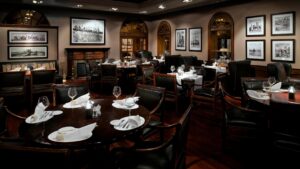 Elegantly set dining area at Cairo Marriott Hotel with round tables and framed photos.