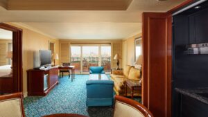 Cairo Marriott suite with seating, TV, and balcony view.