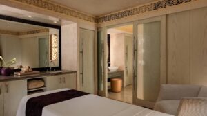 Spa room at the Cairo Marriott Hotel, featuring a massage table and ornate sliding doors.