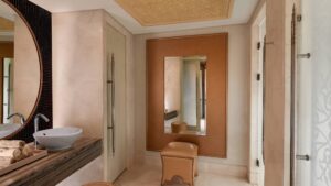 Elegant bathroom at Cairo Marriott with a large mirror, round sink, and decorative ceiling.