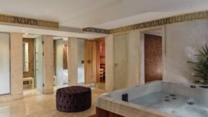 Luxurious bathroom at Cairo Marriott Hotel with a hot tub, sauna, and elegant decor.