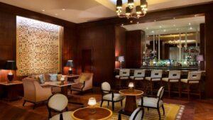 Elegant lounge at The Nile Ritz-Carlton with seating and fully stocked bar.