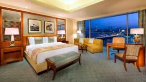 The Nile Ritz-Carlton room: large bed, seating area, city view through a window.