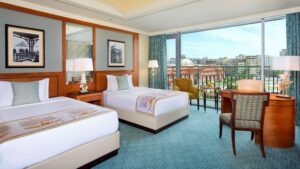The Nile Ritz-Carlton room offers twin beds, city view, elegant chairs, and decor.