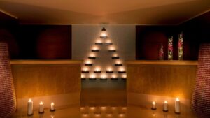 Candles at The Nile Ritz-Carlton arranged in a triangle, with more candles glowing on the floor.