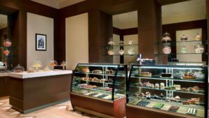 A bakery display at The Nile Ritz-Carlton with assorted pastries in glass cases.