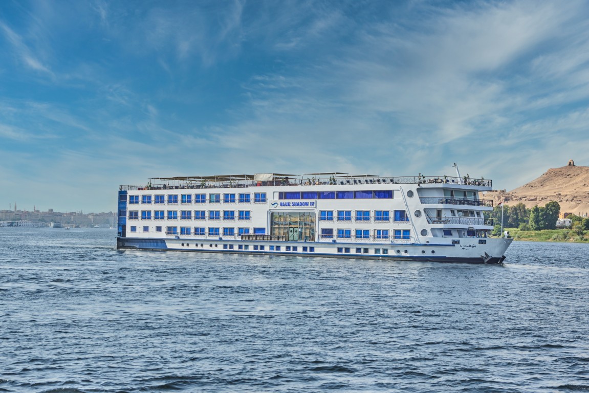 The MS Classic Blue Shadow IV 5* sails on a calm river under a clear, blue sky.