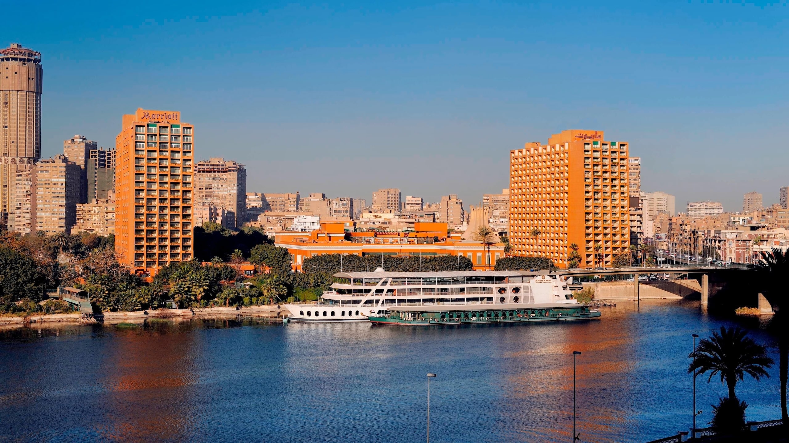 Orange buildings and river cruise ship on the Nile, near Cairo Marriott Hotel.