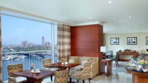 The Nile Ritz-Carlton lounge: city view, wooden decor, seating by large windows.