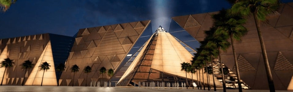 Illuminated pyramid with triangular patterns near the Grand Egyptian Museum at night.