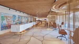 Modern office space at Hyatt Centric Cairo West with marble counter, wall art, and wood ceiling.