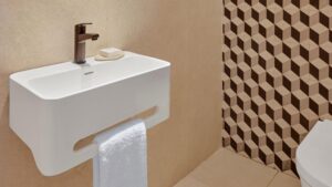 Small white sink with towel rack, soap bar, and Hyatt Centric Cairo West patterned beige tiles.