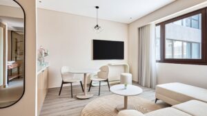 Minimalist living room at Hyatt Centric Cairo West with neutral tones and a wall-mounted TV.