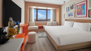 Modern Hyatt Centric Cairo West room with large bed, wall art, TV, and pyramid views.