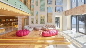 Modern lobby at Hyatt Centric Cairo West with tufted sofas, art-filled walls, and tall windows.