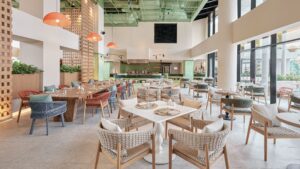 Bright modern restaurant at Hyatt Centric Cairo West with woven chairs and large sunny windows.