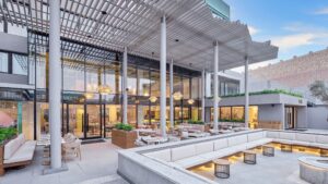 Modern outdoor restaurant patio at Hyatt Centric Cairo West with white seating and large windows.