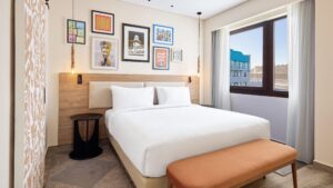 Modern Hyatt Centric Cairo West room with double bed, wall art, and city view.