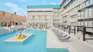 Modern Hyatt Centric Cairo West pool area with lounge chairs and a large inflatable toy in the water.