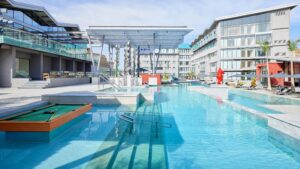 Modern outdoor pool area at Hyatt Centric Cairo West with sun loungers and a pool table.