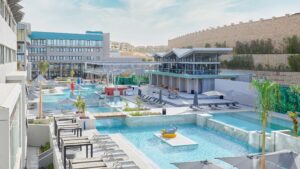 Modern hotel with multiple pools, lounge chairs, and a Hyatt Centric Cairo West restaurant area.